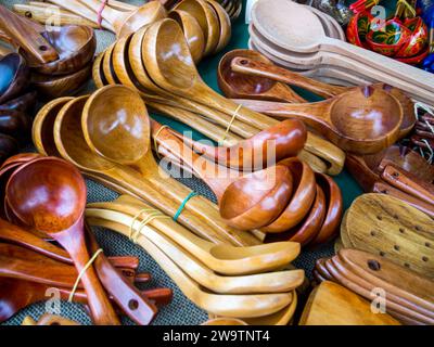 Voronezh, Russia - August 19, 2022: Wooden carved spoons lie on the fair counter Stock Photo