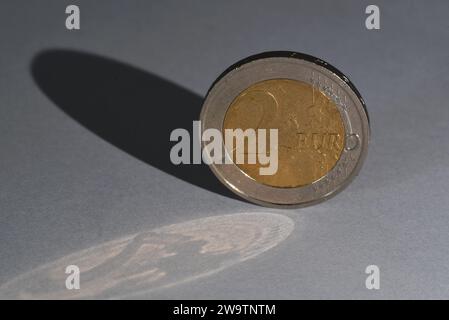 Den Helder, Netherlands. November 2023. A two Euro coin with a double shadow. High quality photo Stock Photo
