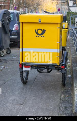 Hamburg, Germany - December, 1, 2023: Postal delivery bike on a sidewalk in Hamburg Stock Photo