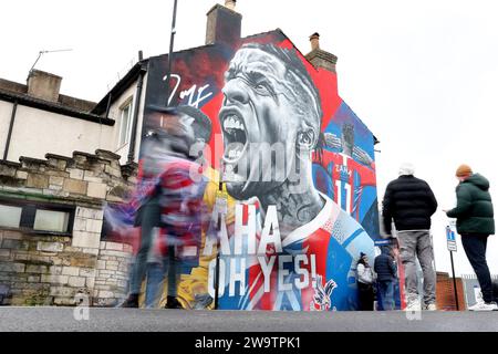 London, UK. 30th Dec, 2023. Fans walk past a mural of former Crystal Palace player Wilfried Zaha before the Premier League match at Selhurst Park, London. Picture credit should read: Paul Terry/Sportimage Credit: Sportimage Ltd/Alamy Live News Stock Photo