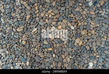 Small sea stones, gravel. Background. Textures Macro photography of river round stones for background. Sea pebbles. Background of pebbles. Multicolore Stock Photo