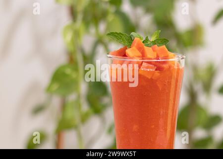 Papaya - mango Juice Smoothies in Glass Cups on White Table: Tropical Fruit Delight with Dazzling Bokeh Background – Perfect for Vibrant and Refreshing Stock Photo