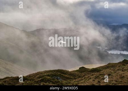 Alcock Tarn seen through low cloud from near Great Rigg, Grasmere, Lake District, Cumbria Stock Photo
