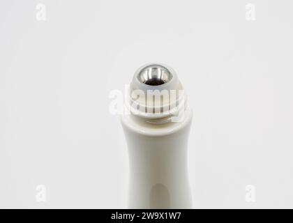 roll-on tube with a metal ball for applying the gel to the skin closeup on white Stock Photo