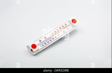 simple household thermometer for measuring outside air temperature closeup on white Stock Photo