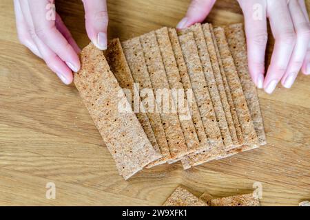 Sorting Bread A woman's hand puts bread close-up. Sorting a small snack in the form ...