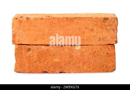 Front view of old red or orange cracked bricks in stack is isolated on white background with clipping path. Stock Photo