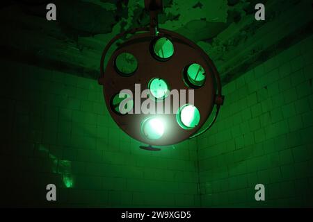 Broken surgical lamp in abandoned hospital. Stock Photo
