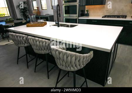 Modern Kitchen Island With Unique Shaped Bar Stools Stock Photo
