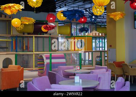 children's play area in a shopping center. An empty playground with bright attractions in a shopping center, an area for children's entertainment in a Stock Photo