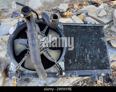 Used car radiator with fan and rubber hose Stock Photo