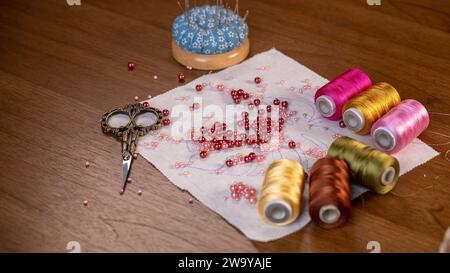 Stitching Elegance: Beaded Embroidery Project with Silk Threads and Needles Stock Photo
