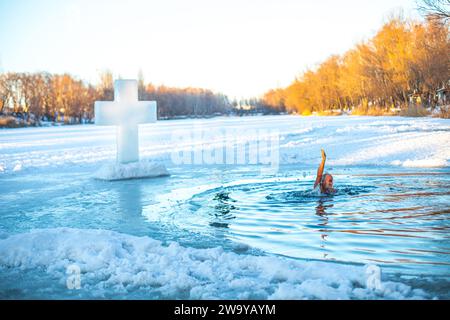 Feast of the Baptism of the Lord. The Orthodox rite of bathing in an ice-hole. Epiphany. believers partake in the religious ritual of bathing in a fro Stock Photo