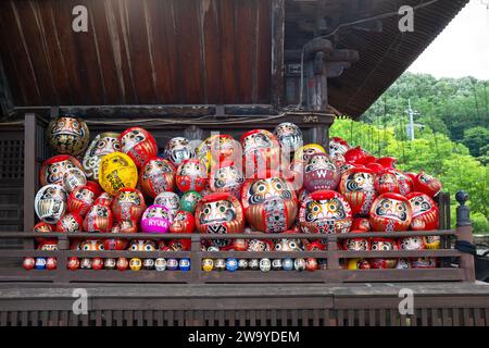 Traditional Japanese daruma dolls piled together at Shorinzan Daruma-ji Temple in Gunma Prefecture, Japan. Stock Photo