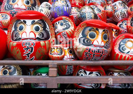 A close up view of a pile of traditional Japanese daruma dolls at Shorinzan Daruma-ji Temple in Gunma Prefecture, Japan. Stock Photo