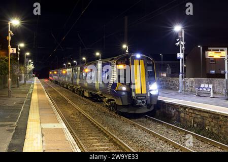 Scotrail Siemens class 380 electric train 380108 calling at Stevenston (Ayrshire) railway station, Scotland, UK at night. Stock Photo