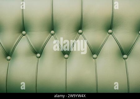 Background with green leather of a sofa Stock Photo