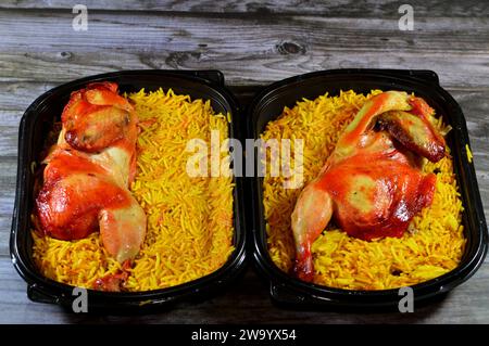 Chicken mandi kabsa with long basmati rice, usually served with tomato dakos sauce, green salad and tahini, Yemen recipe of Yemeni Mandi chicken and r Stock Photo