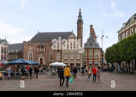 People on the cozy main square opposite the city hall of Haarlem. Stock Photo