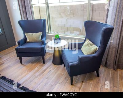 Two High Back Easy Chairs In Master Bedroom Stock Photo