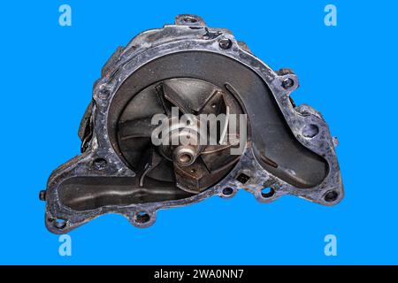 Car water pump on blue background, engine cooling system spare part Stock Photo