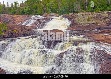 Wild River Tumbling Across Ancient Rocks on the Sand River in Superior Provincial Park in Ontario Stock Photo