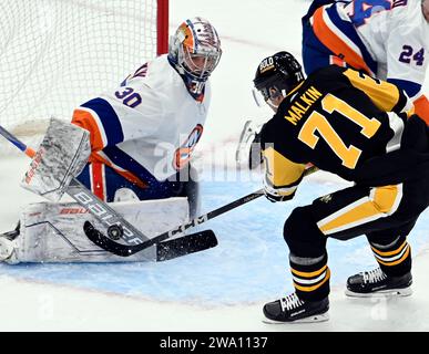 Pittsburgh, United States. 31st Dec, 2023. New York Islanders goaltender Ilya Sorokin (30) blocks the shot of Pittsburgh Penguins center Evgeni Malkin (71) during the second period at PPG Paints Arena in Pittsburgh on Sunday, December 31, 2023. Photo by Archie Carpenter/UPI. Credit: UPI/Alamy Live News Stock Photo