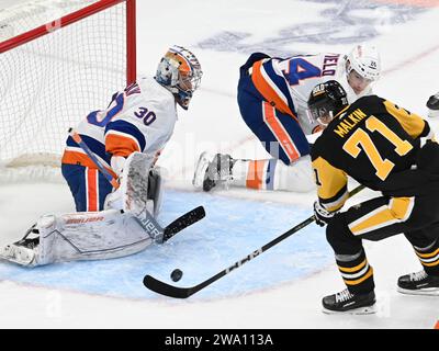 Pittsburgh, United States. 31st Dec, 2023. New York Islanders goaltender Ilya Sorokin (30) turns and blocks the shot of Pittsburgh Penguins center Evgeni Malkin (71) during the second period at PPG Paints Arena in Pittsburgh on Sunday, December 31, 2023. Photo by Archie Carpenter/UPI. Credit: UPI/Alamy Live News Stock Photo