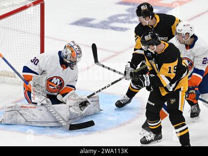 Pittsburgh, United States. 31st Dec, 2023. Pittsburgh Penguins right wing Rickard Rakell (67) and Pittsburgh Penguins right wing Reilly Smith (19) watches as New York Islanders goaltender Ilya Sorokin (30) makes a glove save during the second period at PPG Paints Arena in Pittsburgh on Sunday, December 31, 2023. Photo by Archie Carpenter/UPI. Credit: UPI/Alamy Live News Stock Photo