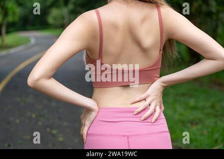 Hurting Neck - Female Runner Showing Pain With Red Circle. Athletic Running  Woman With Injury In Sportswear Rubbing Touching Upper Back Muscles Outside  After Exercising And Training. Stock Photo, Picture and Royalty