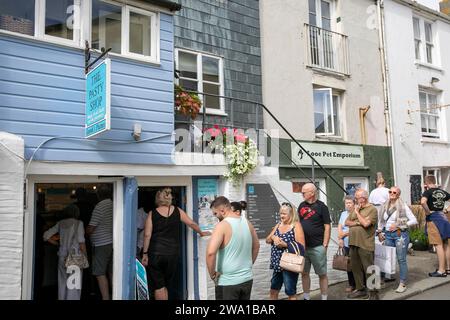 Looe Cornwall, town centre and people queue for Cornish pasties from Sarah's famous pasty shop, England,UK,2023 Stock Photo
