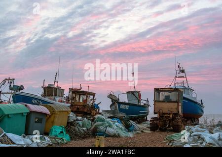 Hastings, East Sussex, UK. 1st January 2024. Brief colourful sky at sunrise at Hastings Harbour, on an otherwise grey overcast New Year's Day. Carolyn Clarke/Alamy Live News Stock Photo