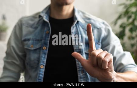 Man showing gesture in sign language on white background Stock Photo