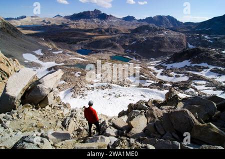 A man looks out towards Mount Humphreys from Snow Tongue Pass on the Sierra High Route, CA. Stock Photo