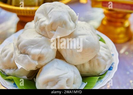 Close-up of stuffed steamed bun on plate Stock Photo