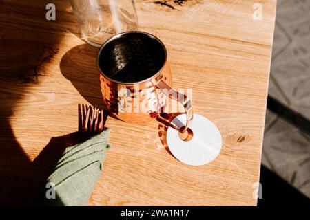 Moscow Mule cocktail cup on harvest table in sunlight Stock Photo