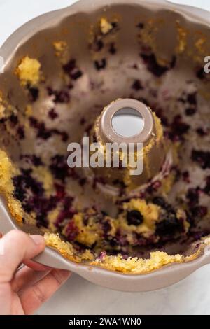 Washing dirty aluminum bundt cake pan Stock Photo