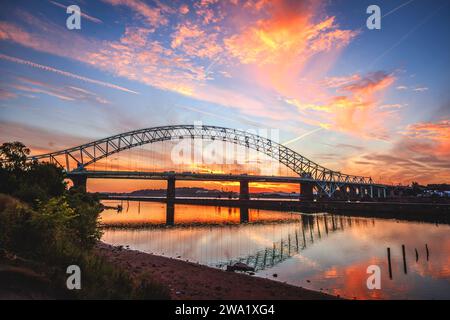Widnes Runcorn Queensway bridge at sunset with Manchester ship canal. Stock Photo