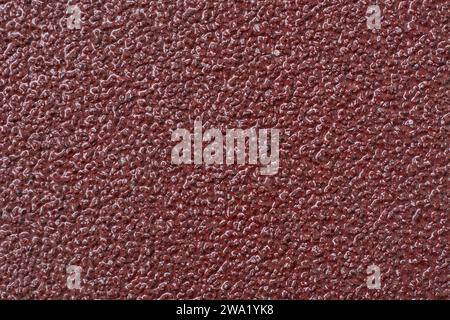 sandpaper surface texture, close-up macro view of P40 coarse-grit abrasive commonly used for heavy sanding tasks, abstract background in full frame Stock Photo