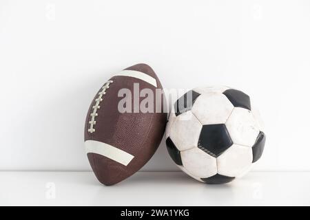 stuffed football and soccer ball with reflection on white background Stock Photo