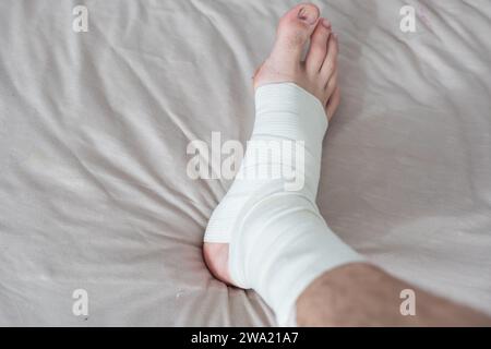 man using put on elastic bandage with legs having leg pain Stock Photo