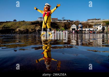 The RNLI mascot on the beach at the Loony Dook New Year's Day dip in the Firth of Forth at Kinghorn in Fife. Picture date: Monday January 1, 2024. Stock Photo