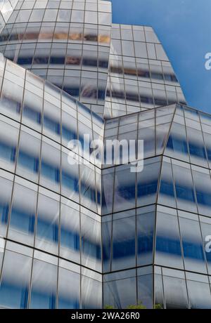 Frank Gehry’s first NYC commission, the billowing-sails-shaped IAC Building, was conceived as metal-clad; the client insisted on white glass instead. Stock Photo