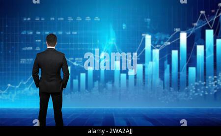 man in suit standing in front of graphs and indicators for stock markets Stock Photo