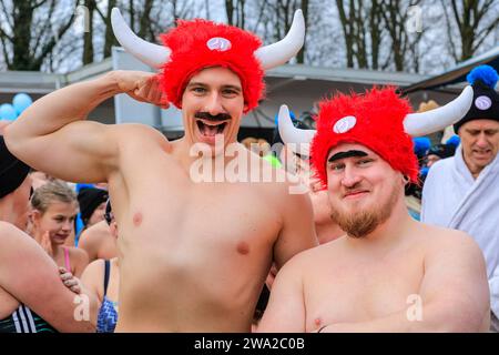 Haltern, Germany. 01st Jan, 2024. Two 'Viking Swimmers' at the start line. A record 590 registered swimmers, the highest number in many years, plus visitors, have fun at the annual New Year's Day swim, an open water swimming event which takes place at Haltern Lake in the town of Haltern, North Rhine Westphalia. Despite unpredictable weather with rain, many brave the run along the beach and into the cold lake in costumes to celebrate the new year in style. All proceeds of the event go to local charities. Credit: Imageplotter/Alamy Live News Stock Photo