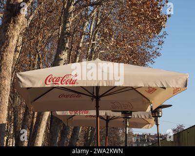 TURIN, ITALY - CIRCA FEBRUARY 2023: Coca Cola Sign On Alfresco Bar Umbrella Stock Photo