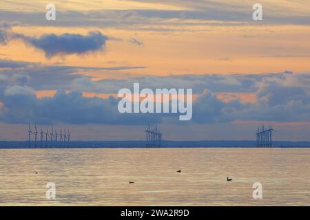 Windfarm on the horizon at sunset, Redcar, North Yorkshire, England, UK. Stock Photo