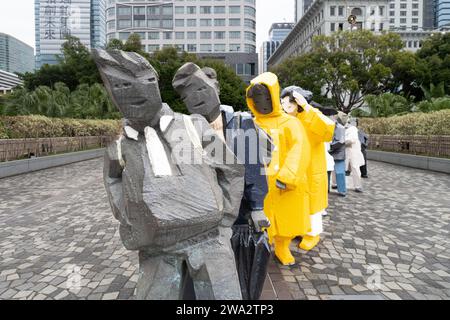 'Lining up,' a sculpture of painted bronze from Ju Ming Living World Series, portrays a group of nine life-sized people standing in a line Stock Photo