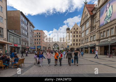 People walk through the Karlstor Gate on the popular Neuhauser Straße shopping street in Munich, Bavaria, Germany. Stock Photo