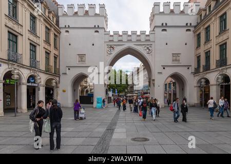 People walk through the Karlstor Gate on the popular Neuhauser Straße shopping street in Munich, Bavaria, Germany. Stock Photo